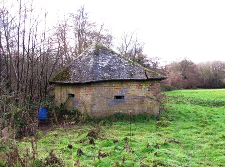 A Shellproof Type 24 at Buxted facing the River Uck, this pillbox has a pitched roof made from a thin concrete based mix supported by timbers . The defence still bears traces of disruptive camouflage painting. It was reportedly constructed by a firm that specialised in building farm barns. Pic by Tim Denton.