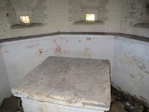 A new and un recorded 8 sided pillbox in Aldershot Command, this pillbox defends a main road approach into a village. Note a very unusual central table in place of blast wall, straight shelves and white washed interior. Tim Denton April 2014